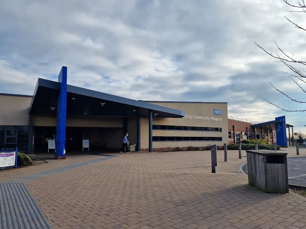 East Riding Community Hospital entrance with modern architecture, blue accents, and a paved pathway in front.