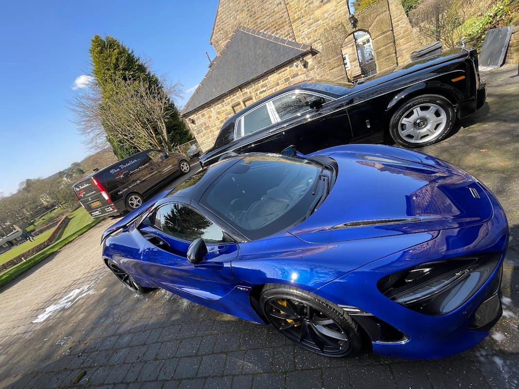 Luxury cars parked in a scenic area with stone buildings and greenery in Bradfield, Yorkshire.