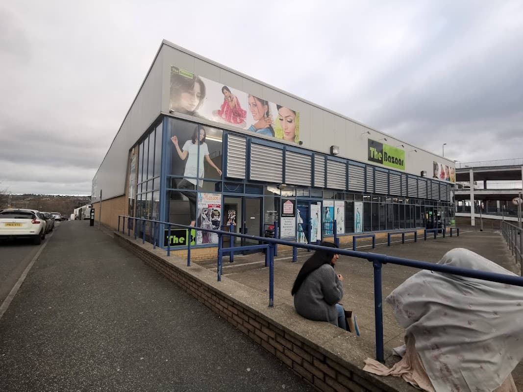 The Bazaar shopping centre in Bradford, featuring large promotional banners and a grey overcast sky.