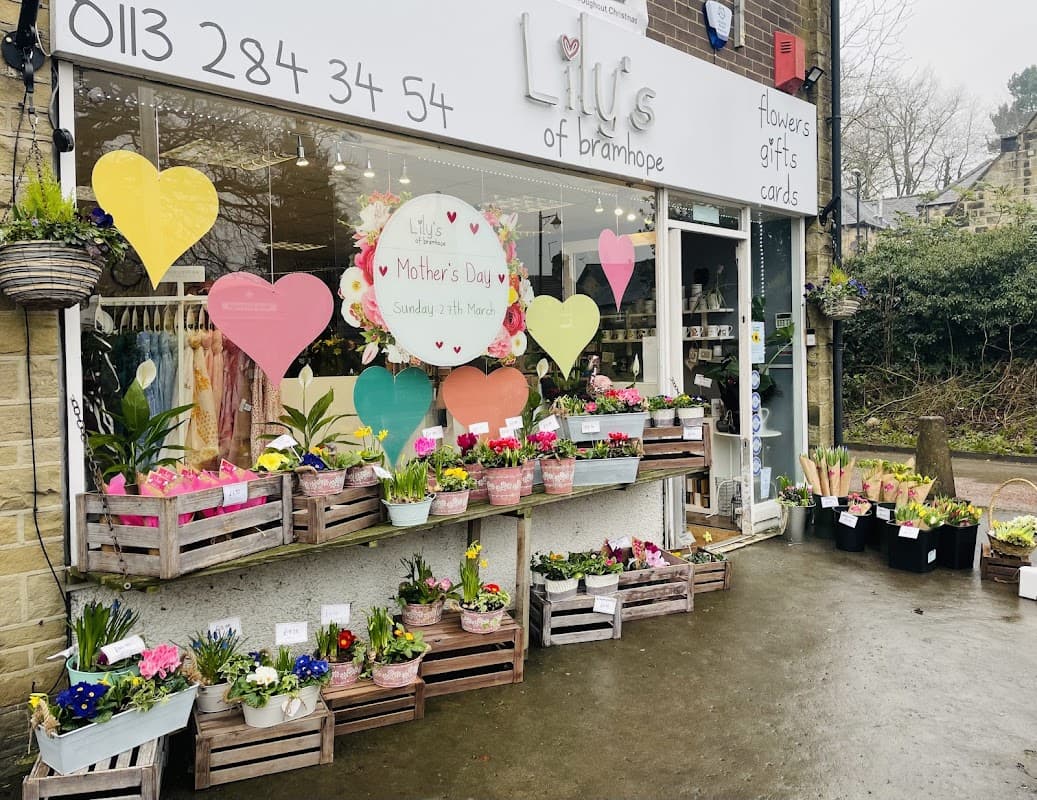 Colorful flower displays and heart-shaped decorations adorn the storefront of Lily's of Bramhope, a florist in Yorkshire.