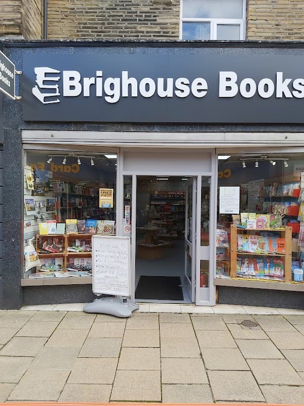 Entrance of Brighouse Books featuring bookshelves, a signboard, and a welcoming display.
