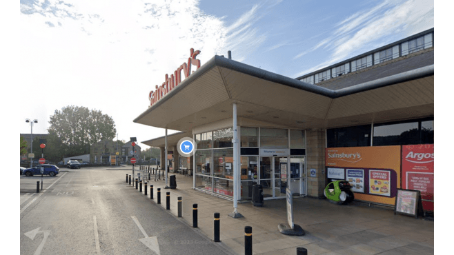 Pay & Display parking near Sainsbury's, with signage and a clear view of the store entrance in Brighouse, Yorkshire.