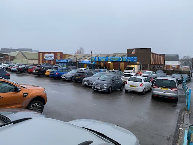 Pay & Display car park in Brightside, Yorkshire, featuring various parked cars and a cloudy, overcast sky.