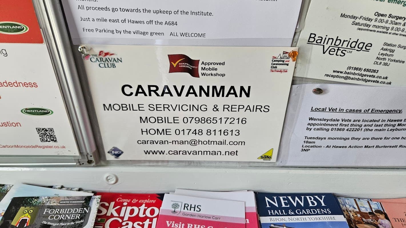 Sign for "Caravanman" detailing mobile servicing and repairs, with contact information and approval logos.