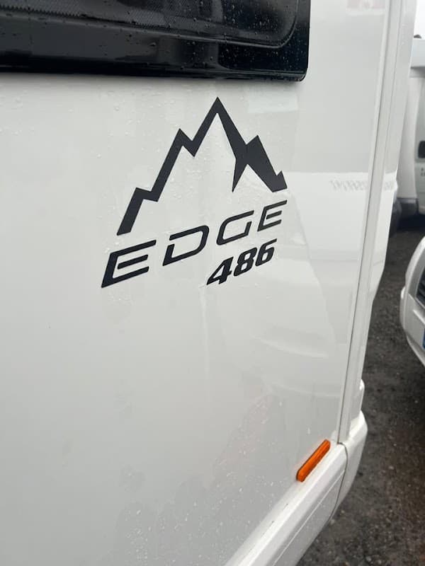 Logo featuring mountain peaks with "EDGE 486" in bold text on a white motorhome.