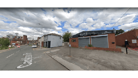 Pay & Display parking sign on a street in Canklow, Yorkshire, with buildings and cloudy sky in the background.