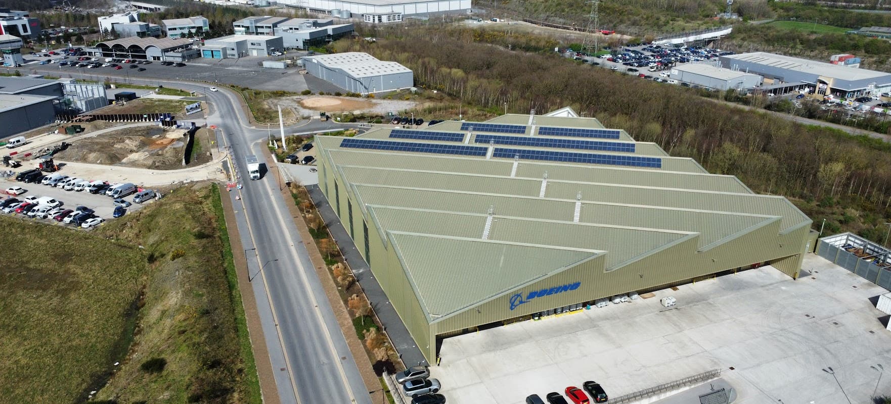 Aerial view of Boeing Car Park in Carbrook, featuring a large building with solar panels and adjacent parking areas.