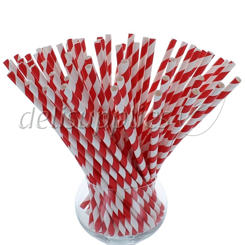 A glass vase filled with red and white striped drinking straws.