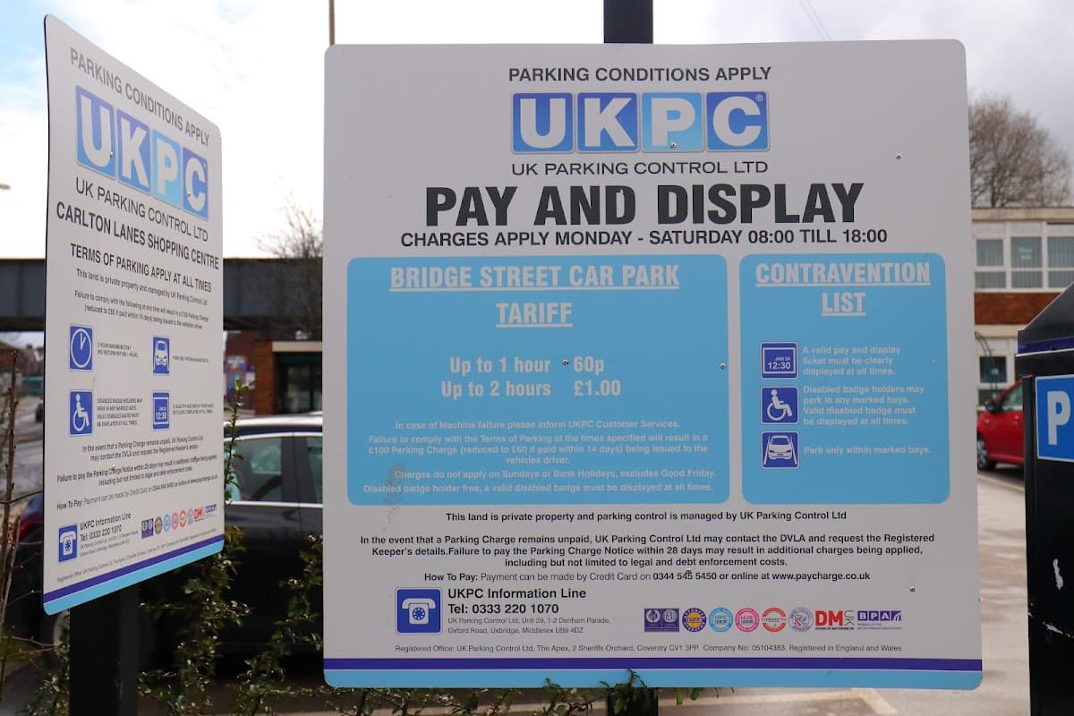 Signage detailing parking conditions and fees for Bridge Street Car Park in Castleford, Yorkshire.