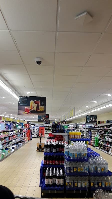Interior of ALDI store in Catterick Garrison, featuring aisles with shelves of beverages and household products.