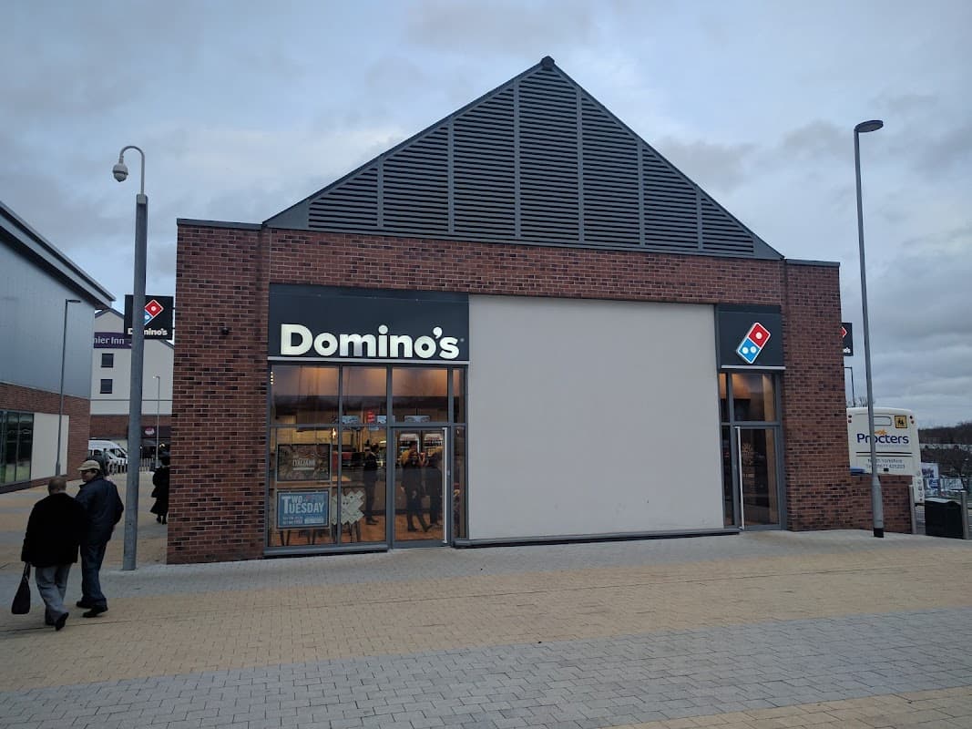 Domino's Pizza storefront in Catterick Garrison, featuring a modern design and large windows.