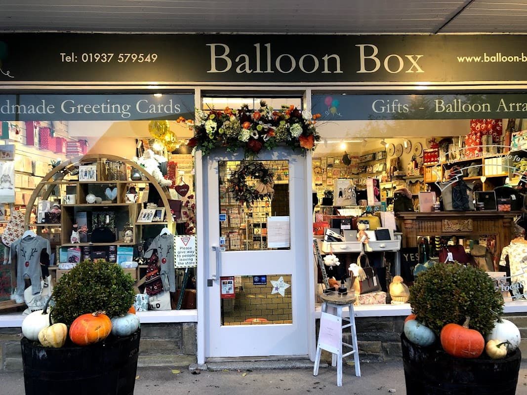 Shopfront of Balloon Box in Collingham, featuring colorful gifts, greeting cards, and seasonal decorations.