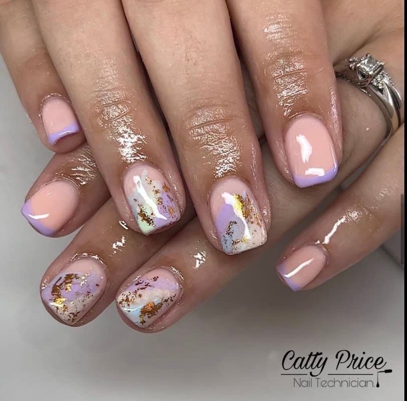 Elegant manicured nails featuring pastel colors, gold accents, and artistic designs.