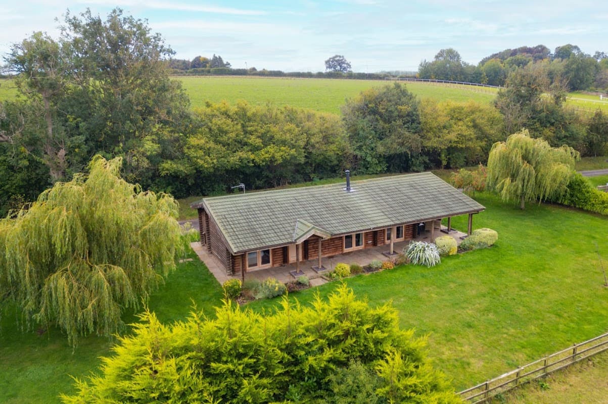 Lodge surrounded by lush greenery and trees, set in a tranquil rural landscape in Constable Burton, Yorkshire.