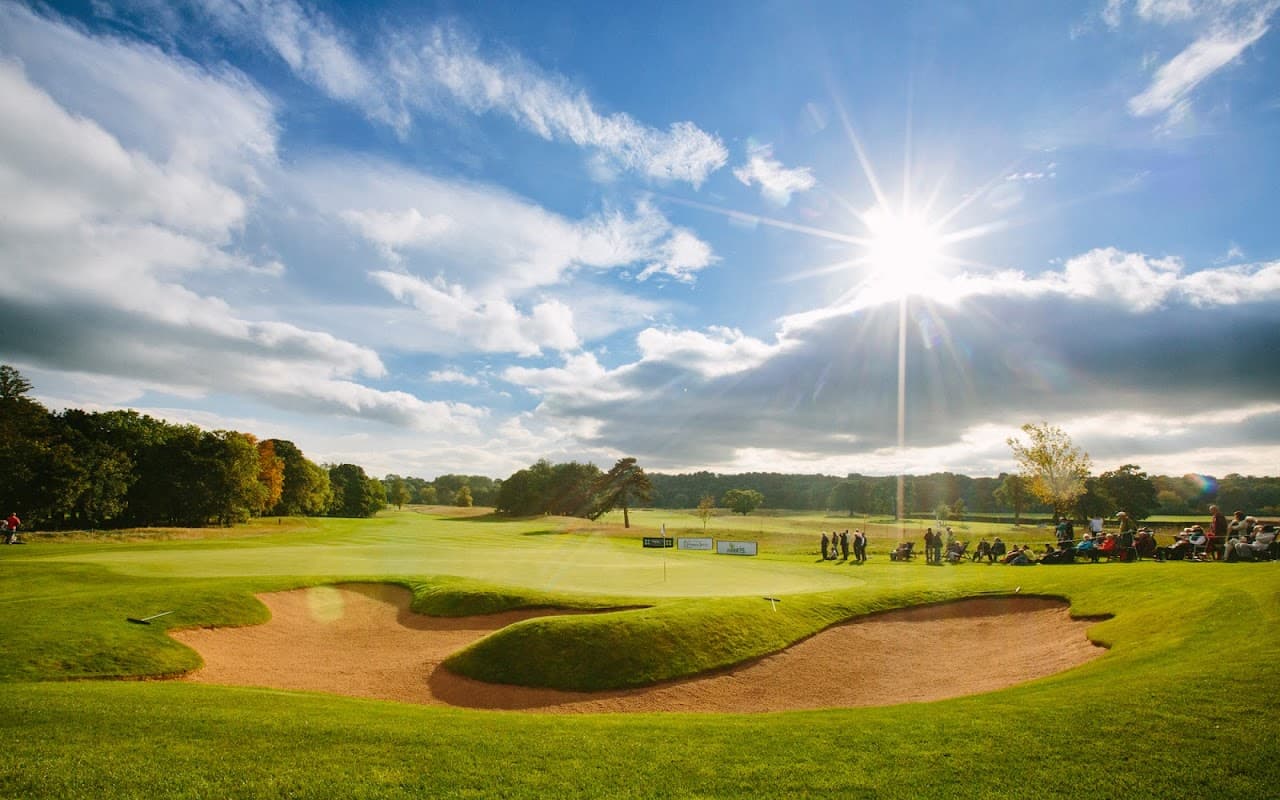Sunny golf course at Rockliffe Hall, featuring sand traps and lush green fairways under a bright sky.
