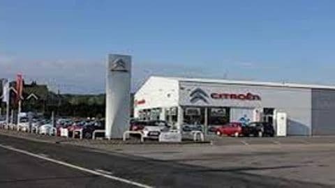 Citroën dealership in Cross Hills, Yorkshire, featuring a modern building and a lineup of cars outside.