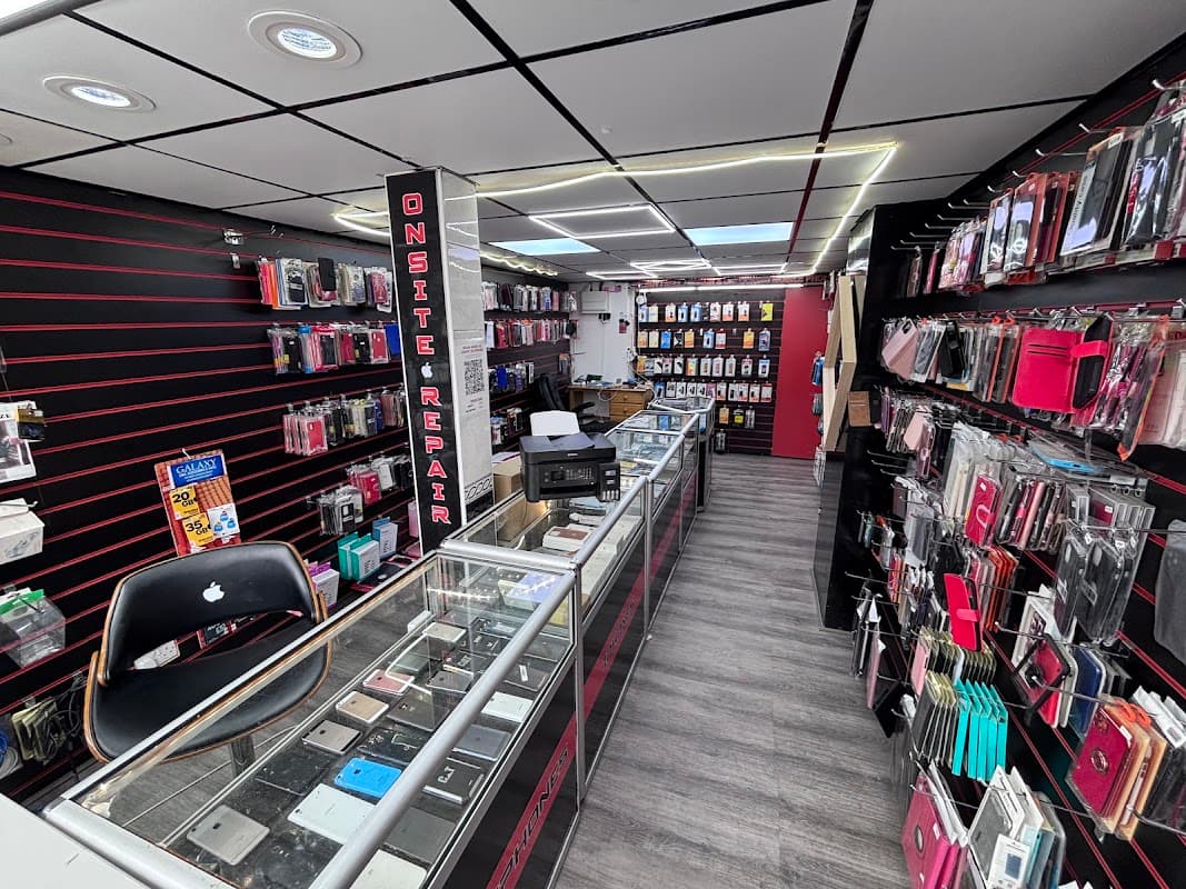 Inside a printing shop with display cases, various phone accessories, and a repair area in a modern setting.