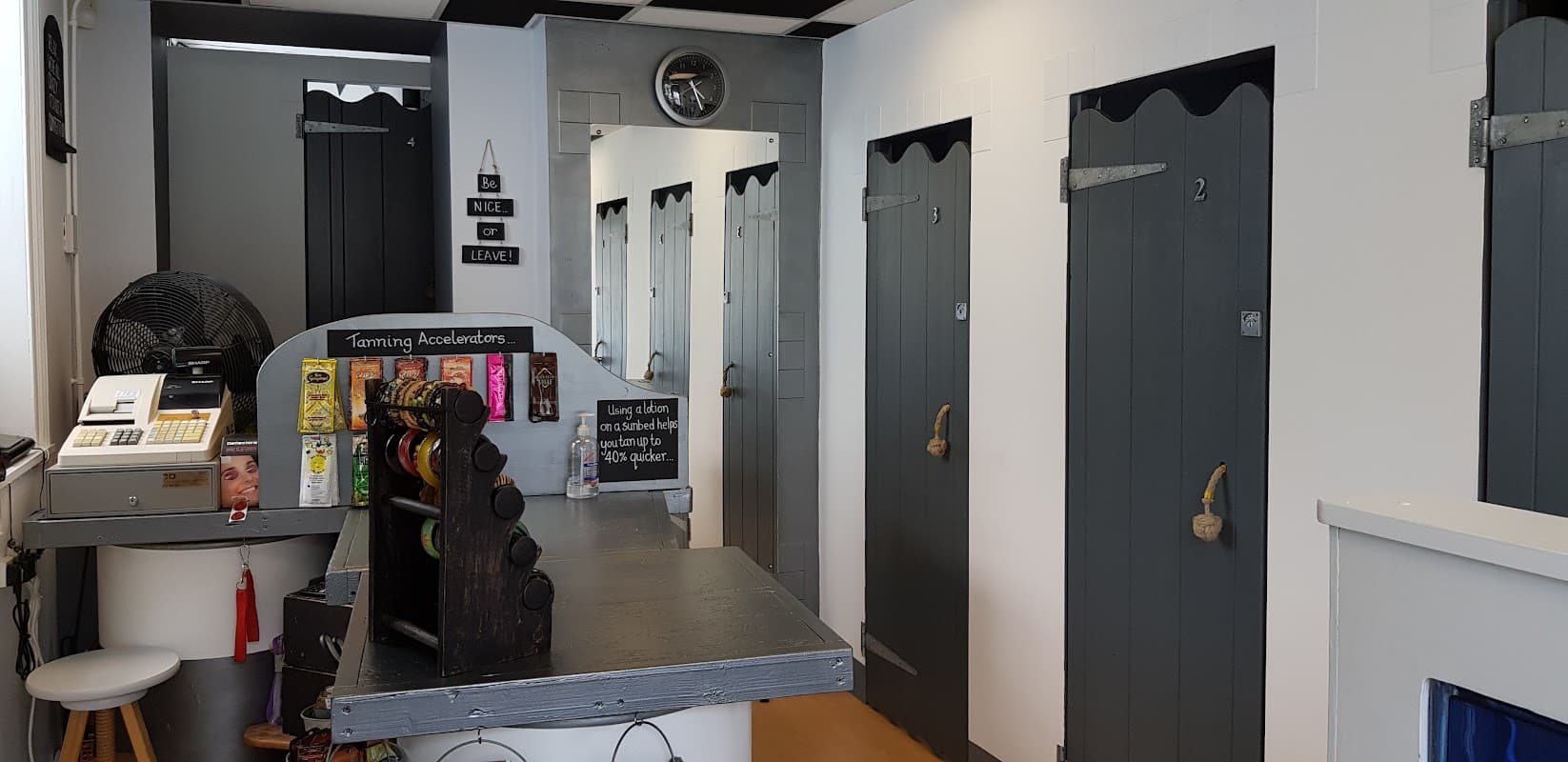 Interior of "Standing Room Only" with a reception desk, lockers, and numbered changing rooms in a modern design.