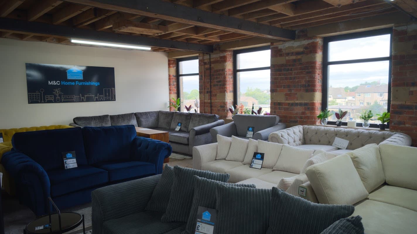 Showroom interior featuring various sofas, large windows, and decorative plants in Cullingworth Mills, Yorkshire.