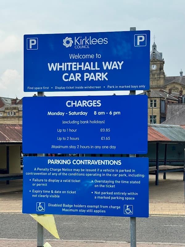 Welcome sign for Whitehall Way Car Park with parking charges, rules, and operating hours displayed prominently.