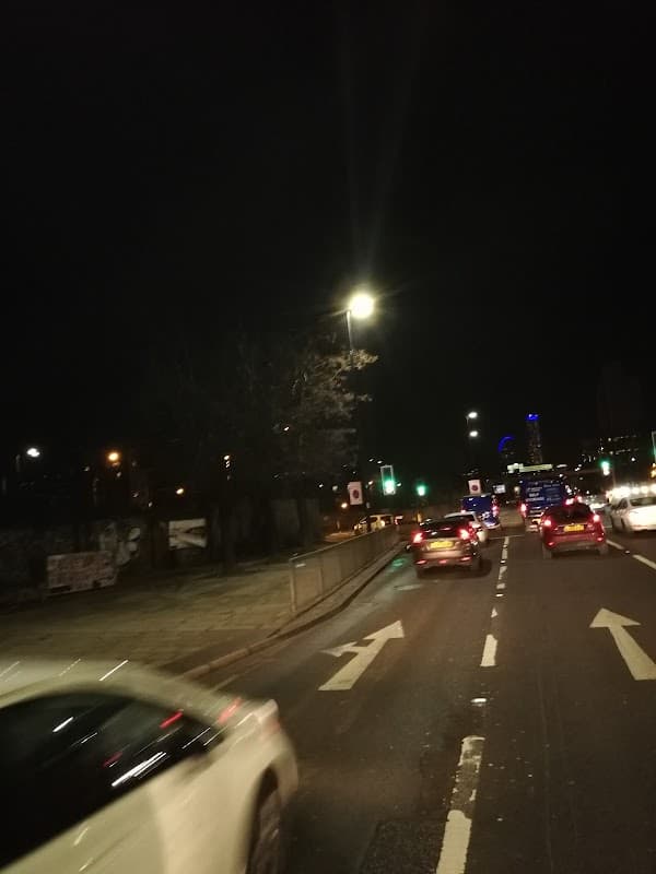 Chappell Drive West Car Park at night, with cars driving and streetlights illuminating the area.