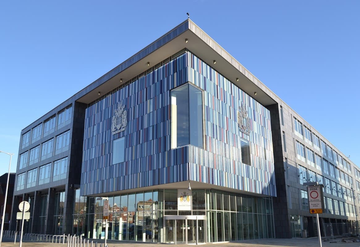 Modern building with colorful paneling, large windows, and the Doncaster Council emblem prominently displayed.