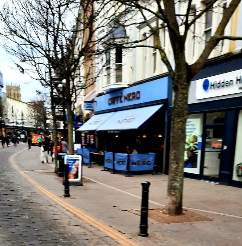Waterdale Shopping Centre featuring cafes, shops, and trees lining the walkway in Doncaster, Yorkshire.