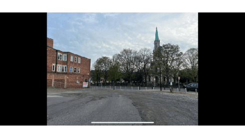 Pay & Display parking area in Doncaster, featuring a church tower and trees in the background.
