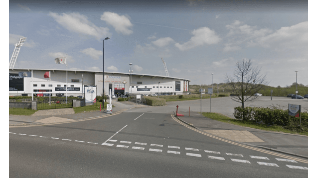 Pay & Display parking area in Doncaster, Yorkshire, near a sports venue with clear skies and green landscaping.