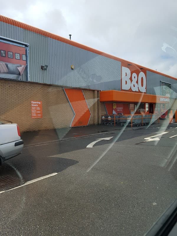 B&Q store exterior in Bradford with orange and gray facade, entrance, and shopping carts outside.