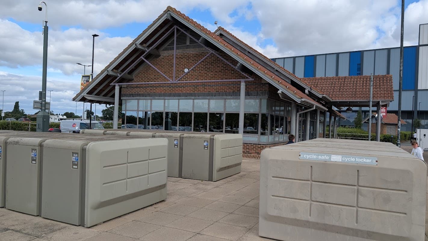 Monks Cross Park & Ride building with large windows, cycle lockers, and a cloudy sky in Earswick, Yorkshire.