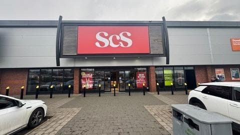 Large storefront with "ScS" logo, promotional signs, and parking area in front of a furniture shop in Eastwood, Yorkshire.
