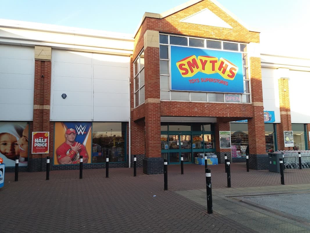 Smyths Toys Superstores entrance with colorful signage, promotional WWE poster, and open storefront in Eckington, Yorkshire.