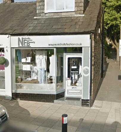 Storefront of Nicholls Fashion and Beauty featuring clothing displays and a welcoming entrance in Exley, Yorkshire.