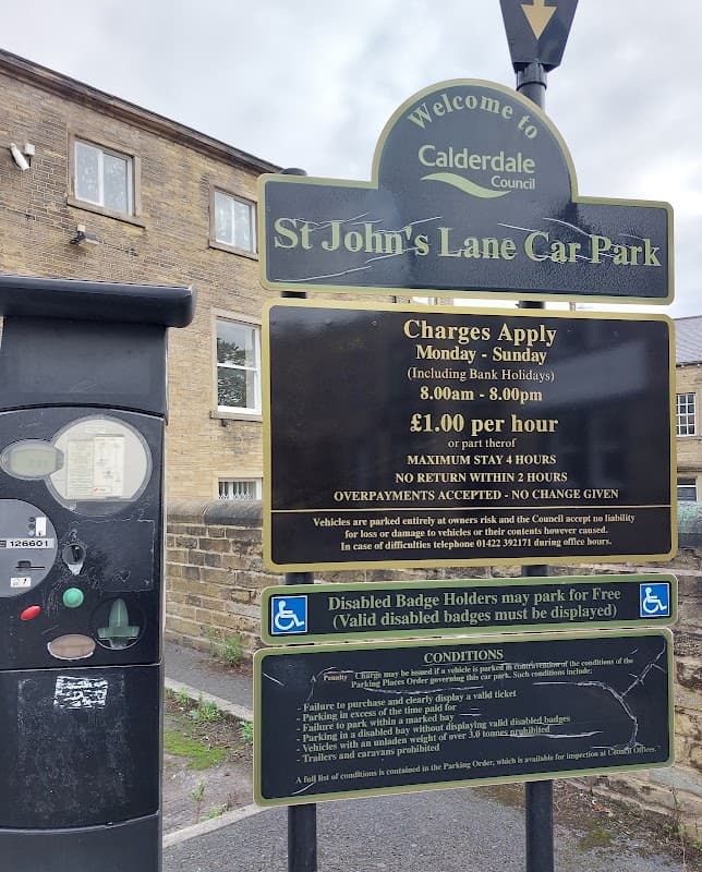 Welcome sign for St John's Lane Car Park, with pay station, parking charges, and conditions displayed.