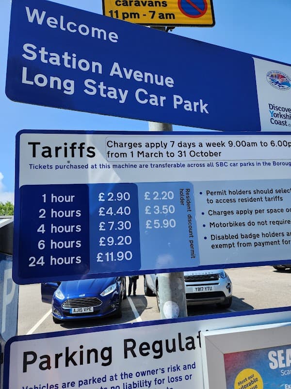 Welcome sign for Station Avenue Long Stay Car Park, displaying parking tariffs and operating hours.