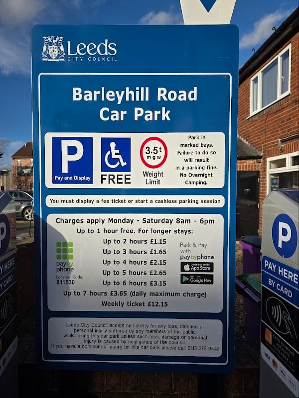 Sign for Barley Hill Road Car Park in Garforth, listing parking fees, hours, and payment options.