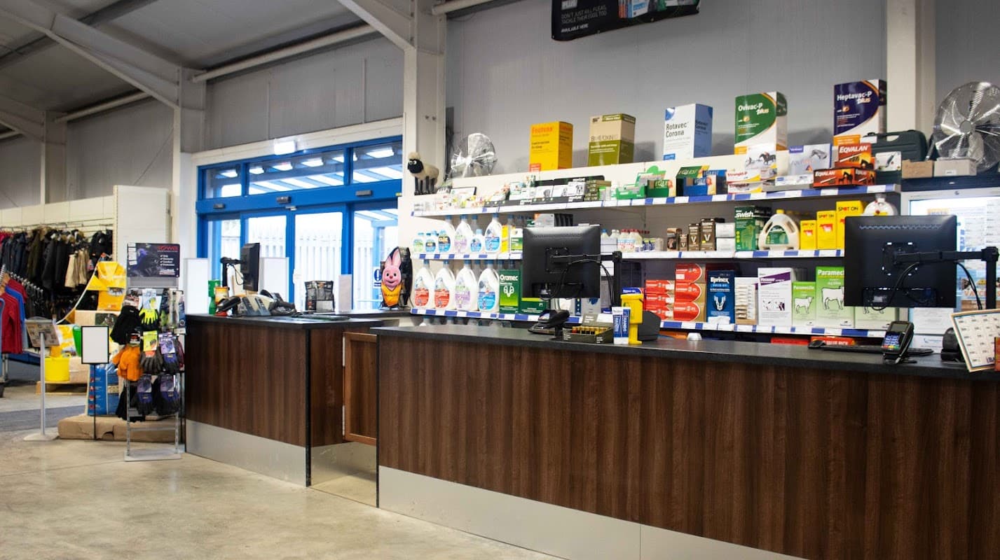 Checkout area with two counters, computers, and shelves stocked with various sports and outdoor products.