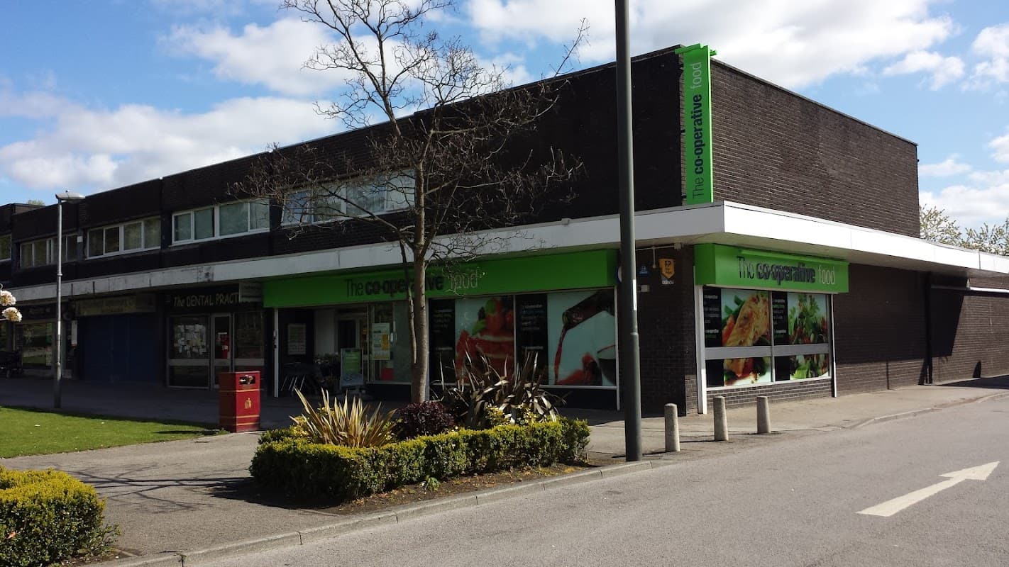 Central Co-op Food store with green signage, large windows displaying food, and a landscaped area in front.
