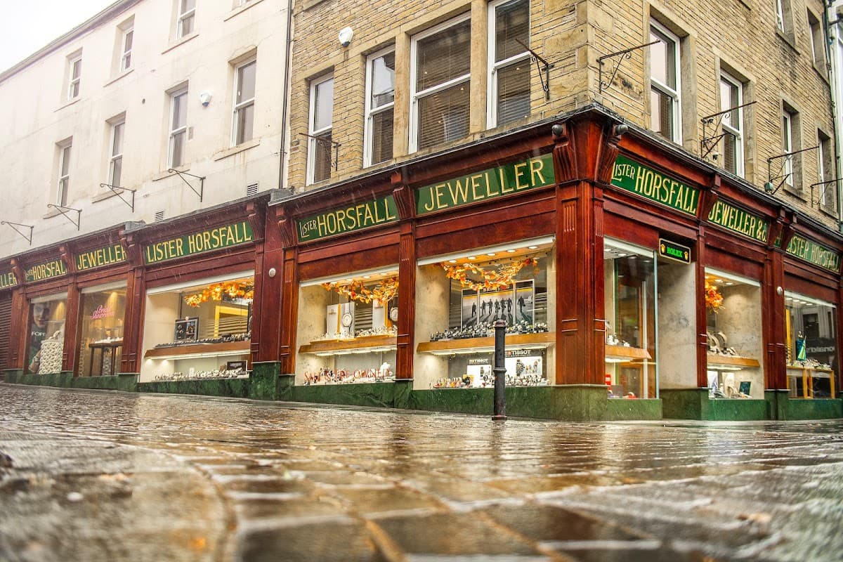 Jewellery shop with large glass windows displaying sparkling items, featuring "Lister Horsfall Jeweller" signage.
