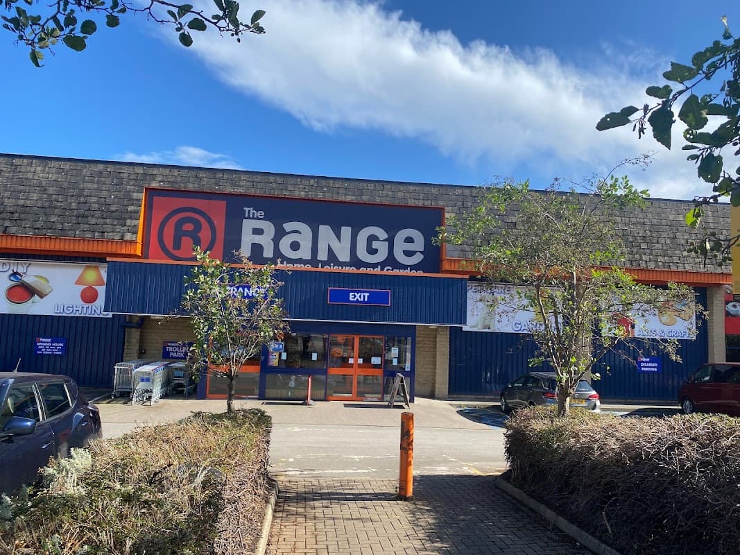 Storefront of The Range in Halifax, featuring a blue exterior, large signage, and a clear sky above.