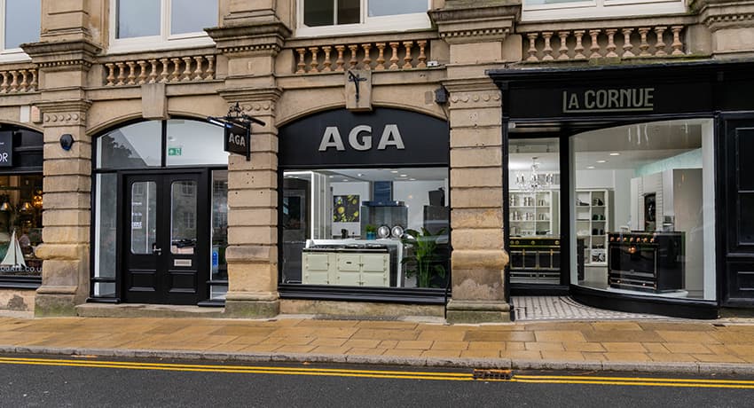 Elegant storefront featuring "AGA" and "La Cornue" signs, large windows showcasing homeware displays in Harrogate.
