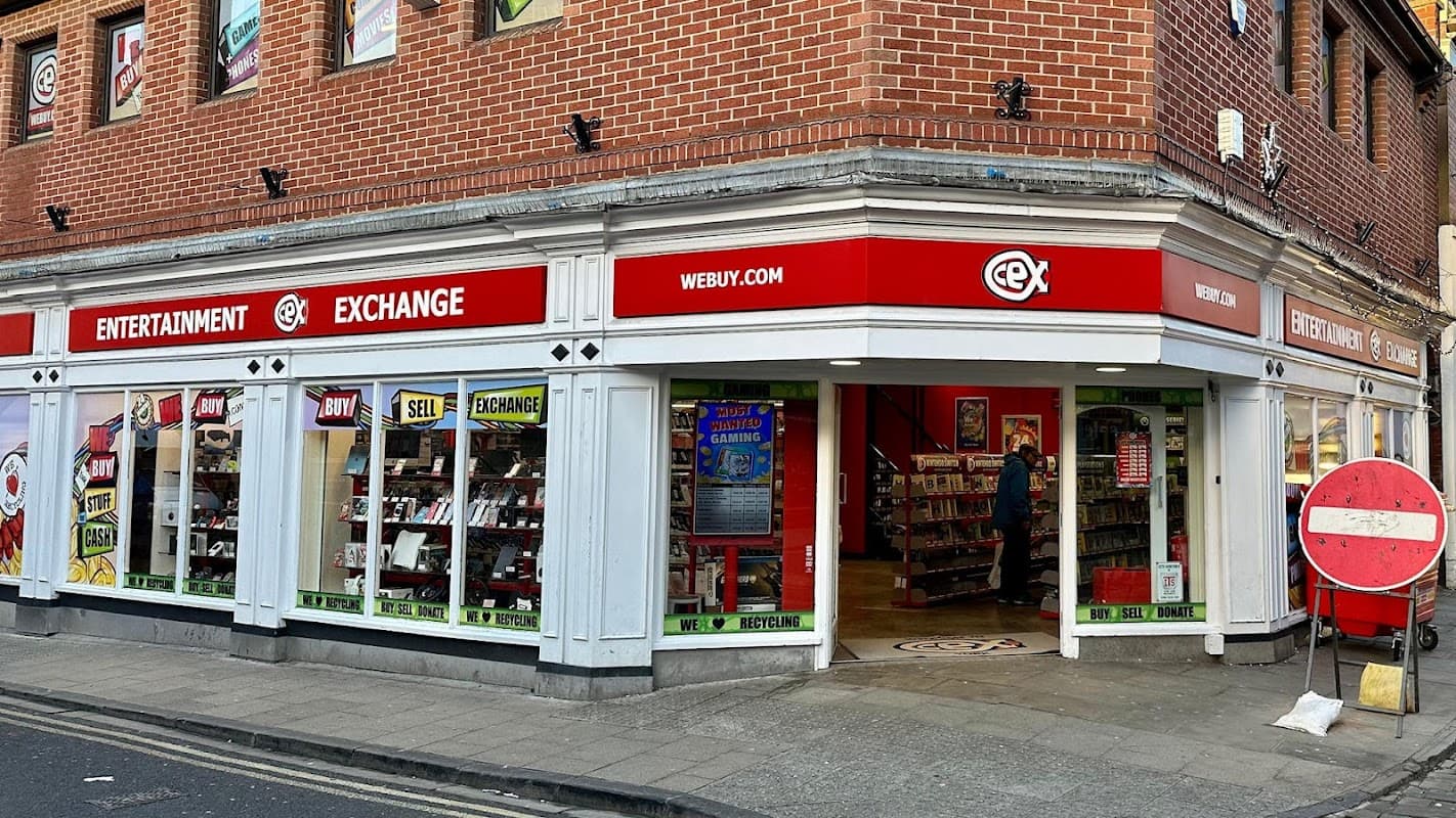 CeX store front in Harrogate, featuring red signage, electronic displays, and a variety of tech products in the windows.