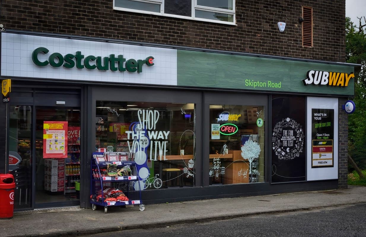 Costcutter and Subway storefronts on Skipton Road, featuring open signs and colorful displays of products.