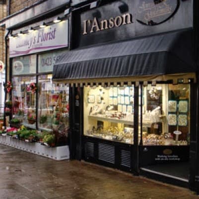 Jewellery shop with display window showcasing rings and necklaces, next to a florist in Harrogate, Yorkshire.