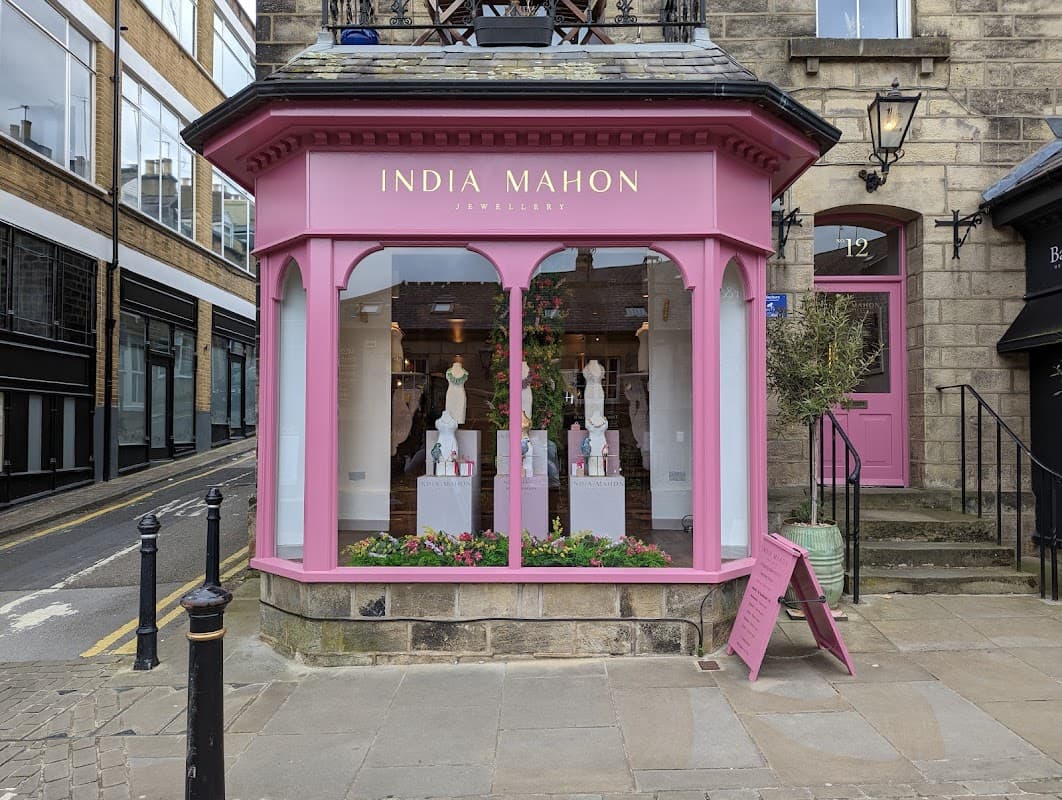 Charming pink storefront of India Mahon Jewellery with elegant displays and floral decorations in Harrogate, Yorkshire.