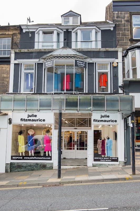 Clothes shop with colorful garments displayed in windows and a welcoming entrance in Harrogate, Yorkshire.