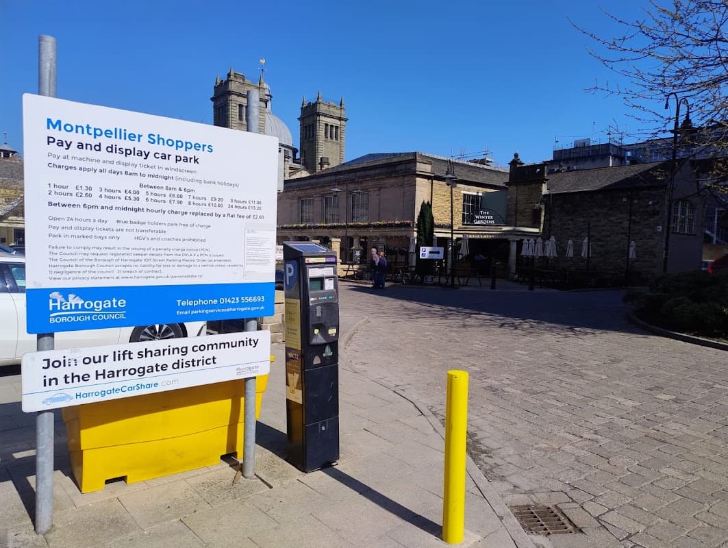 Montpellier Shoppers Pay & Display car park sign, ticket machine, and nearby buildings in Harrogate, Yorkshire.
