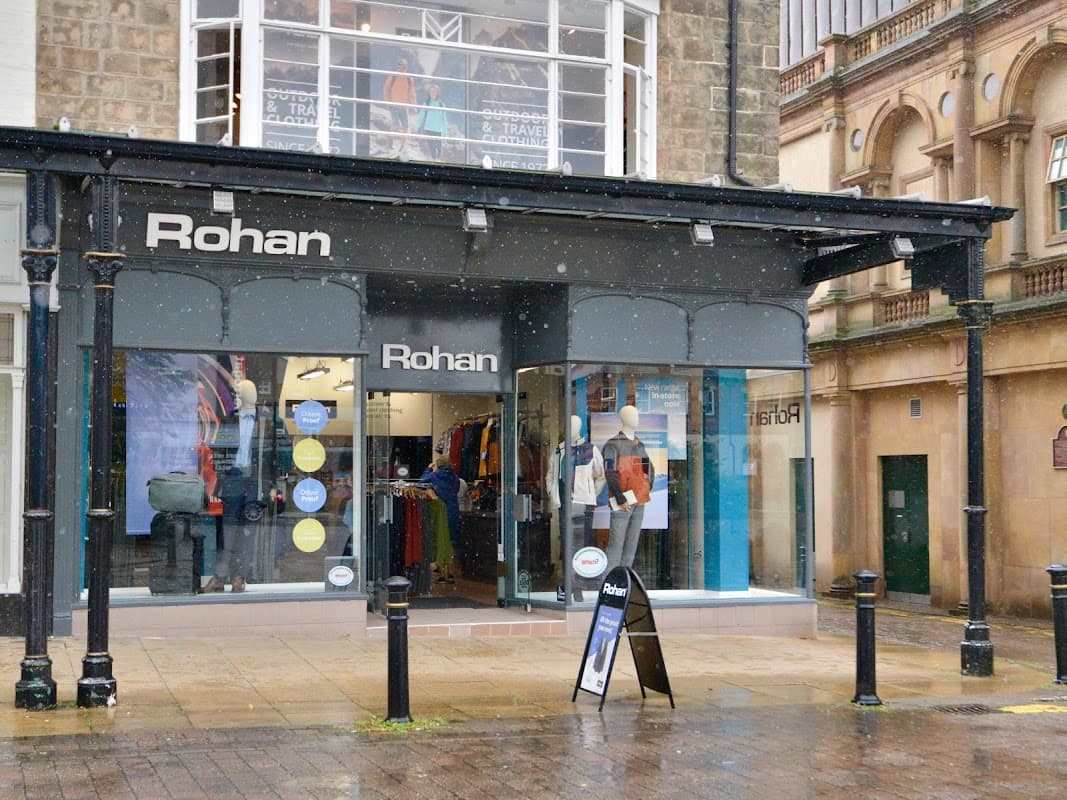 Rohan clothing store with large windows displaying outdoor apparel, located in Harrogate, Yorkshire, on a rainy day.