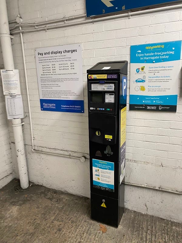 Pay & Display parking machine in West Park Multi Storey Car Park, with signage detailing charges and parking app info.